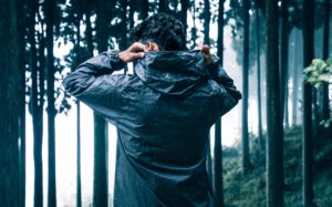 Man putting up the hood of his rain jacket