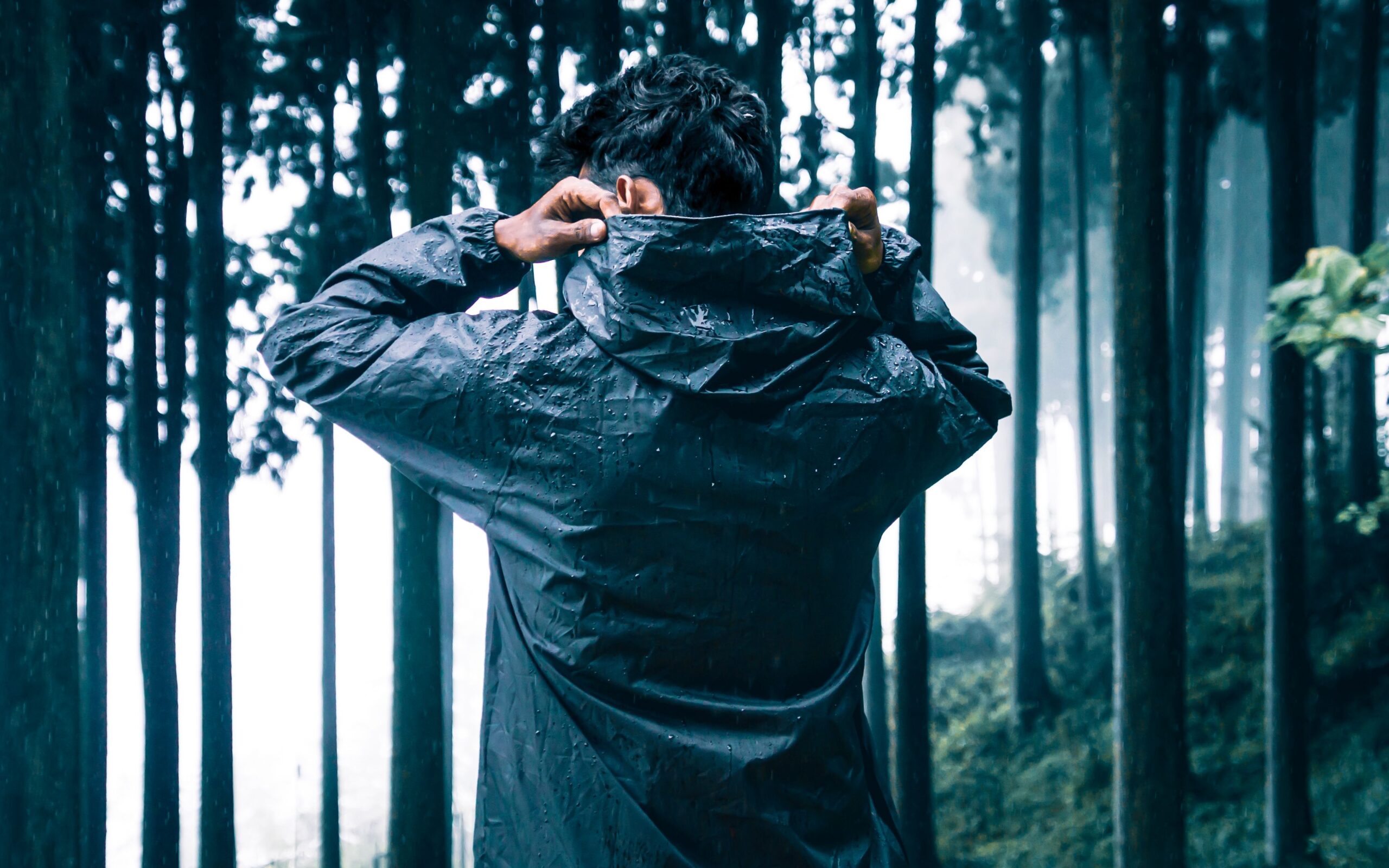 Man putting up the hood of his rain jacket